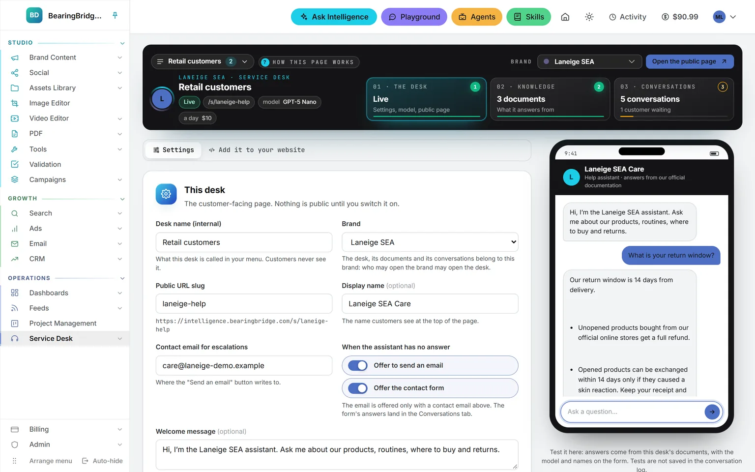 A desk’s settings: public address, display name, contact email, welcome message, model and daily budget, with the live switch, and beside them a phone that has just answered a test question about the return window